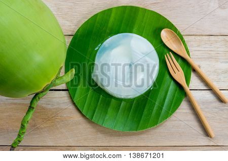 coconut jelly and wooden spoon on wooden background