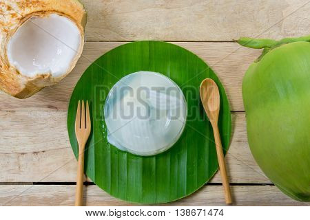 coconut jelly and wooden spoon on wooden background