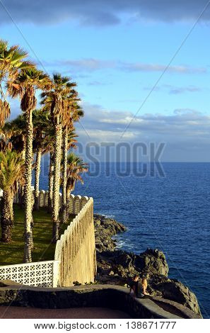 Callao Salvaje Tenerife Canary Islands Spain Europe - June 16 2016: A young couple sitting on a wall at Callao Salvaje coast in Adeje Tenerife