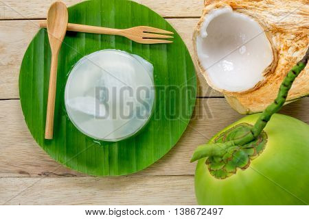 coconut jelly and wooden spoon on wooden background