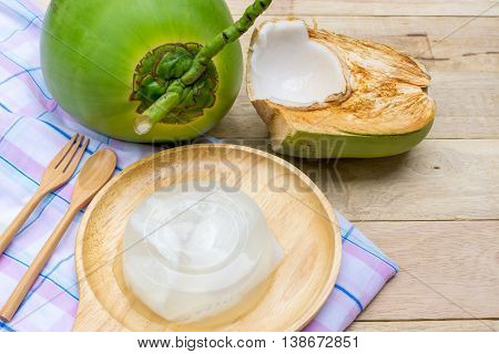 coconut jelly and wooden spoon on wooden background