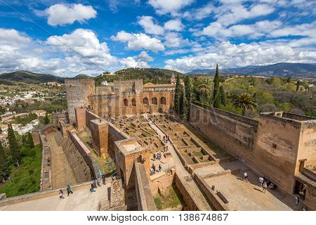 Alhambra de Granada, Spain - April 17, 2016: people and tourists visiting the Alcazaba de Granada, one of the most visited attractions of Andalusia. Aerial view from the tower of fortress.