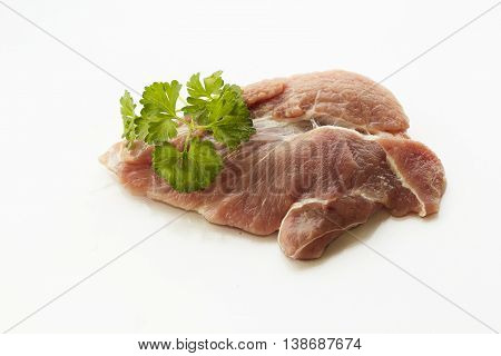 a piece of meat with parsley on white background