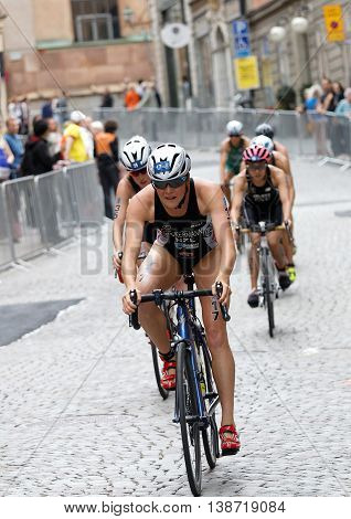 STOCKHOLM - JUL 02 2016: Simone Ackermann and group of female triathlete cyclists cycling downhill on cobblestone in the Women's ITU World Triathlon series event July 02 2016 in Stockholm Sweden