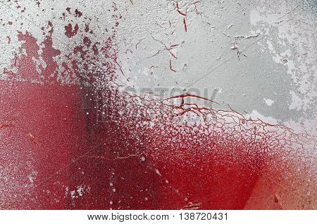 Cracked And Scratched Red And White Paint On Grunge Metal
