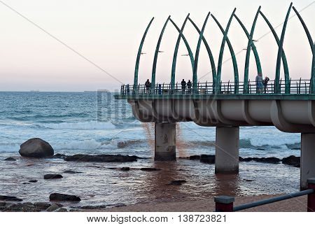 DURBAN SOUTH AFRICA - JULY 11 2016: People on the Millennium Pier at the beach in Umhlanga Rocks