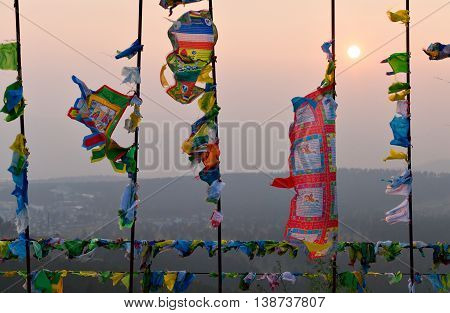 Prayer flags and Hadak at sunset in the Republic of Buryatia. Datsan Rinpoche Bagsha on Bald Mountain in Ulan-Ude, Russia.