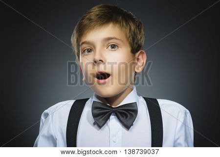 Closeup Portrait of happy boy going surprise isolated on gray background.