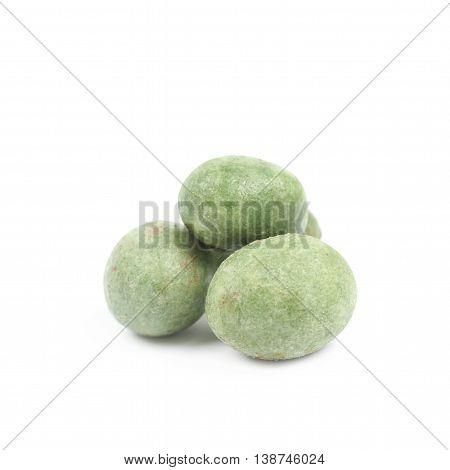 Green wasabi coated peanuts isolated over the white background