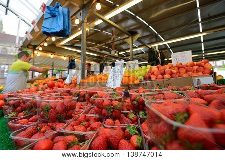 BIRMINGHAM, ENGLAND - JUNE 13: Unknown man trades a fruits in Bull Ring market on June 13, 2013 in Birmingham, England. Birmingham's outdoor Bull Ring market sees over six million shoppers every year