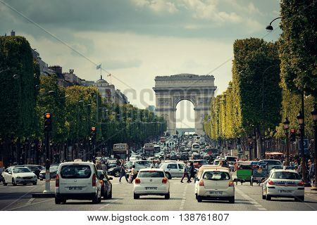 PARIS, FRANCE - MAY 13: street view and Arc de Triomphe on May 13, 2015 in Paris. With the population of 2M, Paris is the capital and most-populous city of France