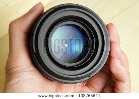 Hand hold camera dslr lens with nice lighting shining on the lens