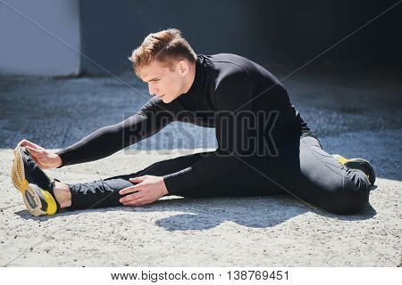 Portrait of an athlete in tight clothing performing a warm-up