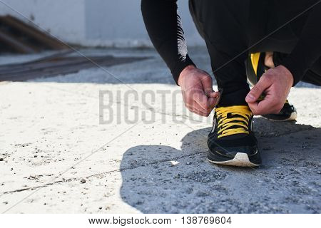 Mens hand tie the laces on sneakers