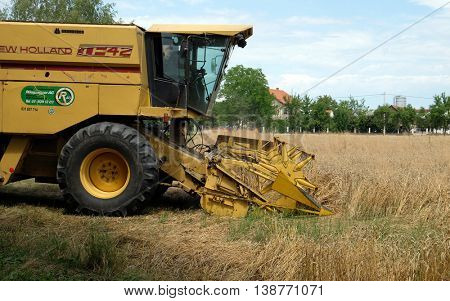 TRNOVEC, CROATIA - JULY 09, 2016: Combine harvester harvest ripe wheat on a farm in Trnovec, Croatia on July 09, 2016
