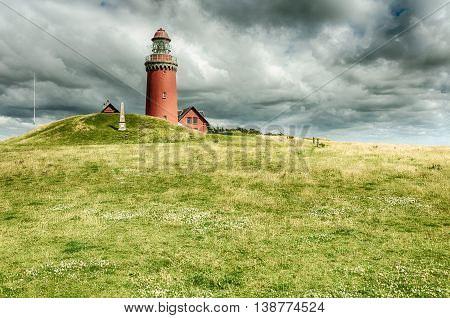 Danmark lighthouse on ameadow with cloudy sky