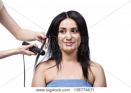 Young woman getting hair straightner isolated on white