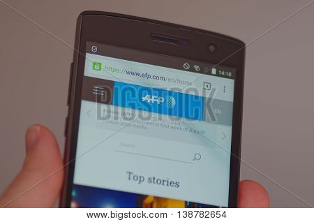 SARANSK, RUSSIA - JULY 17, 2016: A smartphone screen shows Agence France-Presse (AFP) web site on the screen. Selective focus.