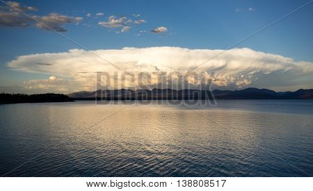 This monster mushrooming cloud billows with light at sunset over Yellowstone Lake