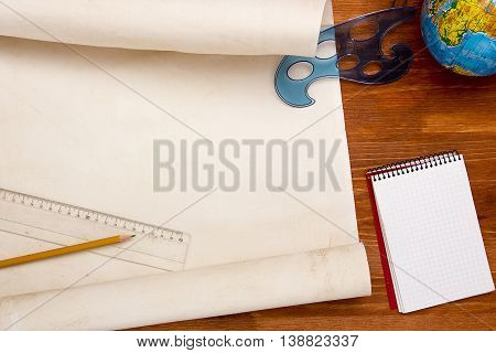 Roll of paper for drawings on a wooden table