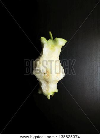 guava eaten to the core on black wooden table