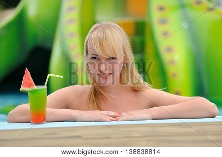 Women Drinking Cocktail In Pool
