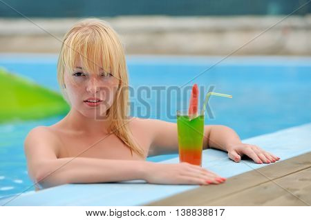 Women Drinking Cocktail In Pool