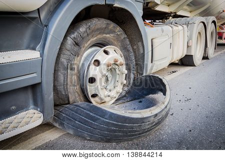 closeup damaged 18 wheeler semi truck burst tires by highway street