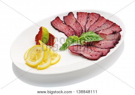 appetizing restaurant food -basturma with lemon on  white background with clipping path