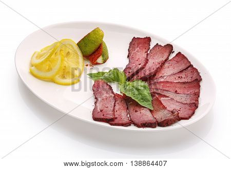 appetizing restaurant food -basturma with lemon on  white background with clipping path