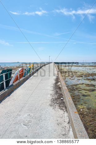coastal scenery with long pier around Penmarch in the Finistere department in Brittany France
