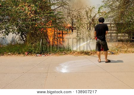 A man is trying to extinguish a fire.