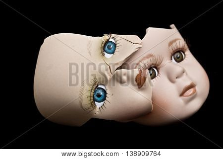 Broken Doll Face and Head on Black Background