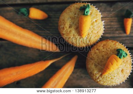 Carrot muffins on a wooden background