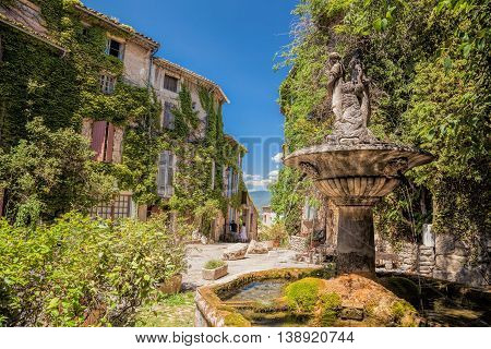 Village Of Saignon With Old Car Against Church In The Luberon, Provence, France