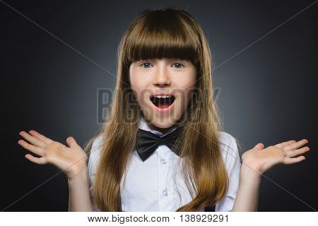 Closeup Portrait of happy girl going surprise isolated on gray background.