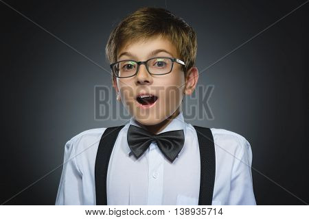 Closeup Portrait of happy boy going surprise isolated on gray background.