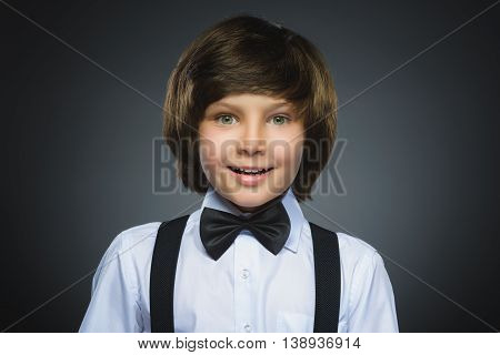 Closeup Portrait of happy boy going surprise isolated on gray background.