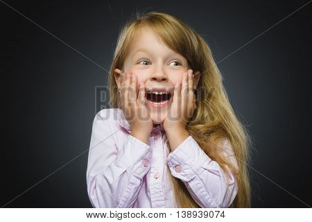 Closeup Portrait of happy girl going surprise isolated on gray background.