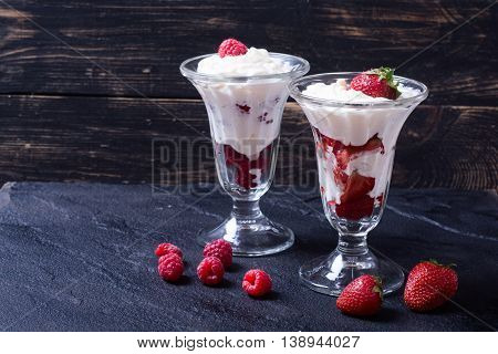 Raspberry & strawberry ice cream on black stone background