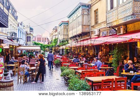 TBILISI GEORGIA - MAY 28 2016: The local restaurant offers the nice summer terrace the best place for the supper on the fresh air on May 28 in Tbilisi.