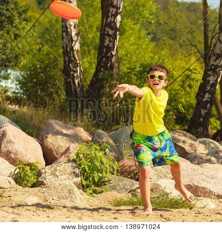 Little Boy Playing With Frisbee Disc.