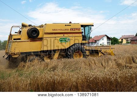TRNOVEC, CROATIA - JULY 09, 2016: Combine harvester harvest ripe wheat on a farm in Trnovec, Croatia on July 09, 2016