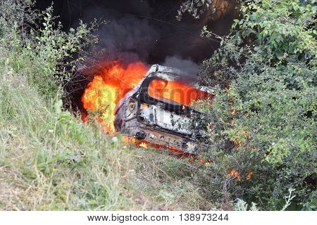 TULCEA, ROMANIA - JUNE 11: Danube Delta Rally special trial windfarm on June 11, 2016 in Tulcea, Romania; car on fire