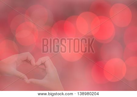 kid hands making a heart shape with sweet background