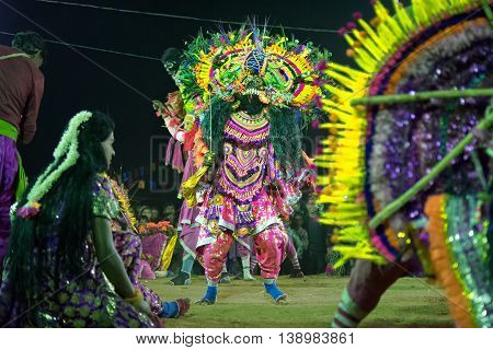 BAMNIA PURULIA WEST BENGAL INDIA - DECEMBER 23RD 2015 : Dancers dressed as monster performing at Chhau Dance festival. It is Indian tribal martial dance performed amongst spectators.
