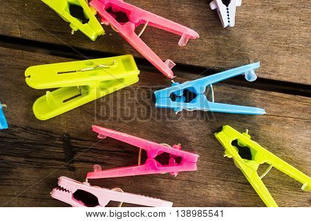 Colorful clothes peg, clothespin on wood background use for dry the clothes under the sun