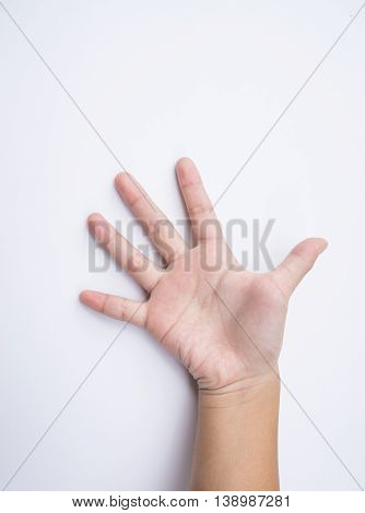 child hand shows the number five on white background