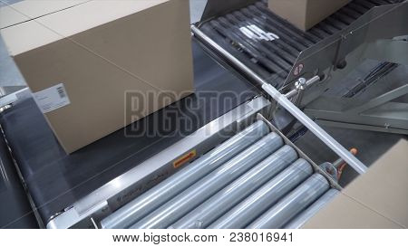Cardboard Boxes On Conveyor Belt In Factory. Cardboard Boxes On Conveyor Belt In Distribution Wareho