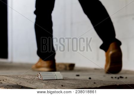 Men Walk Through Piles Of Cigarettes, Ignore Cigarettes.stop Smoking Concept.